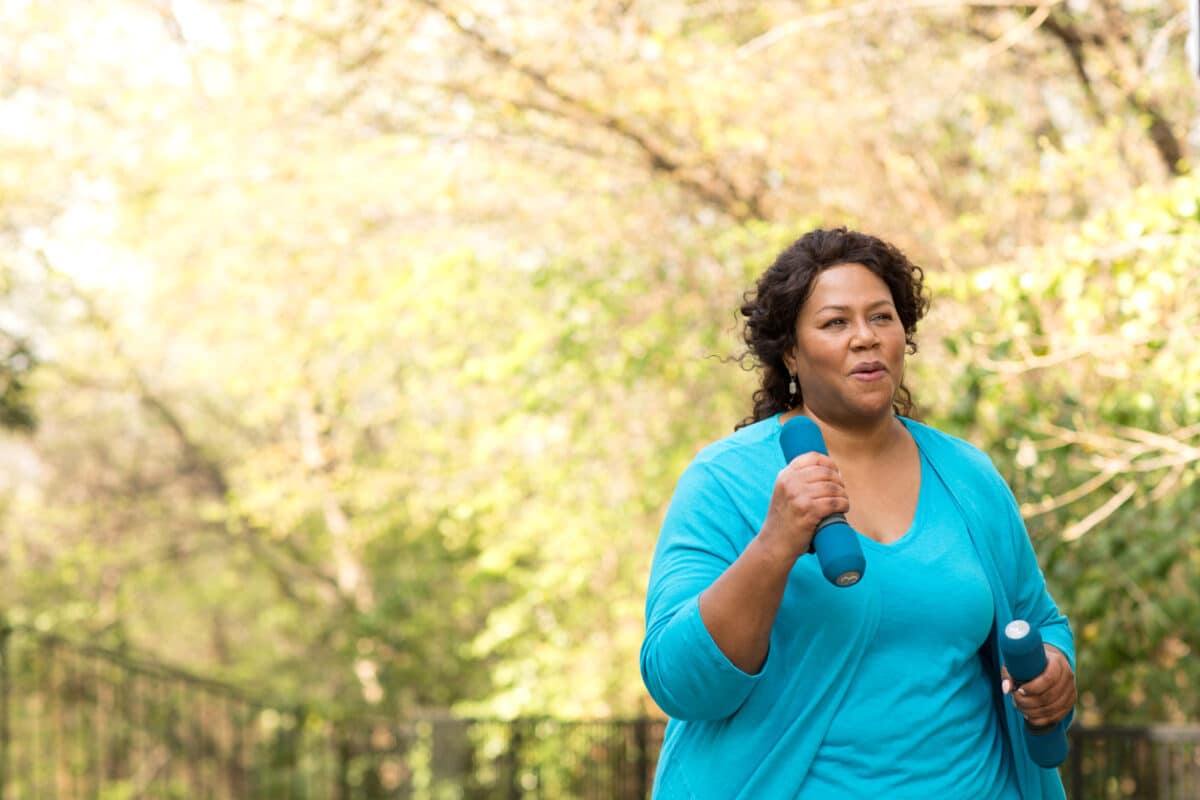 Woman walking with hand weights