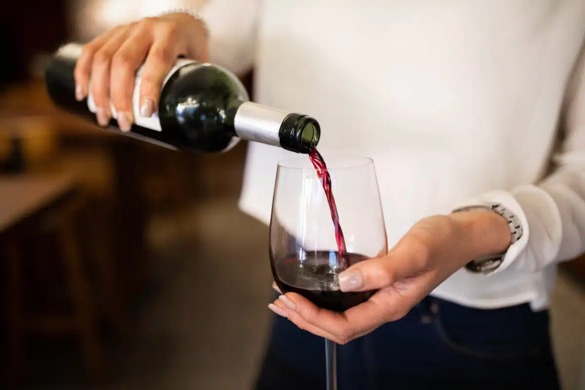 Woman pouring a glass of wine