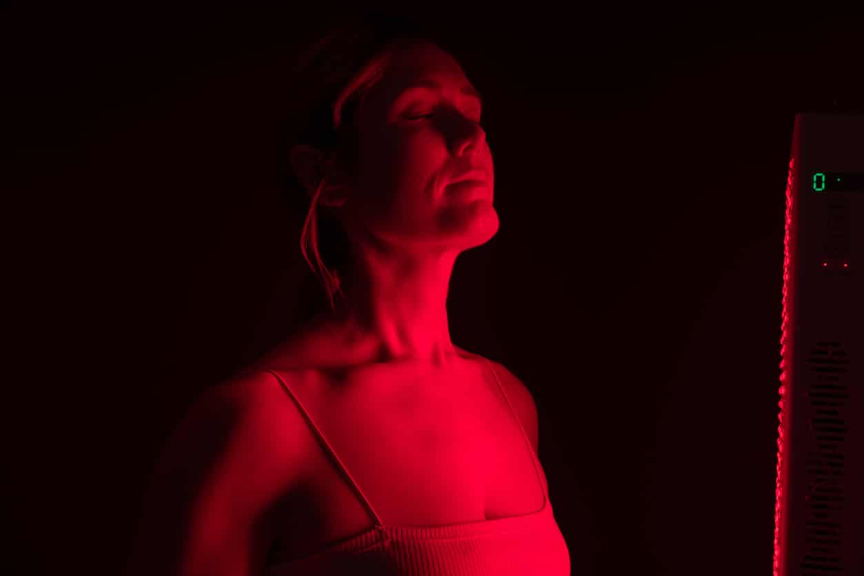 Woman getting red light therapy from a red light device; LED Masks
