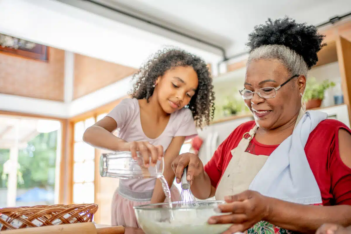 Grandma and granddaughters making cookies