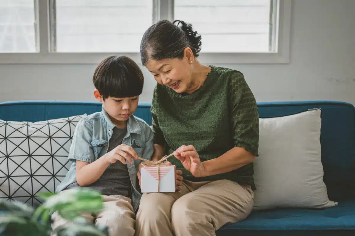 Grandmother and grandson opening gift