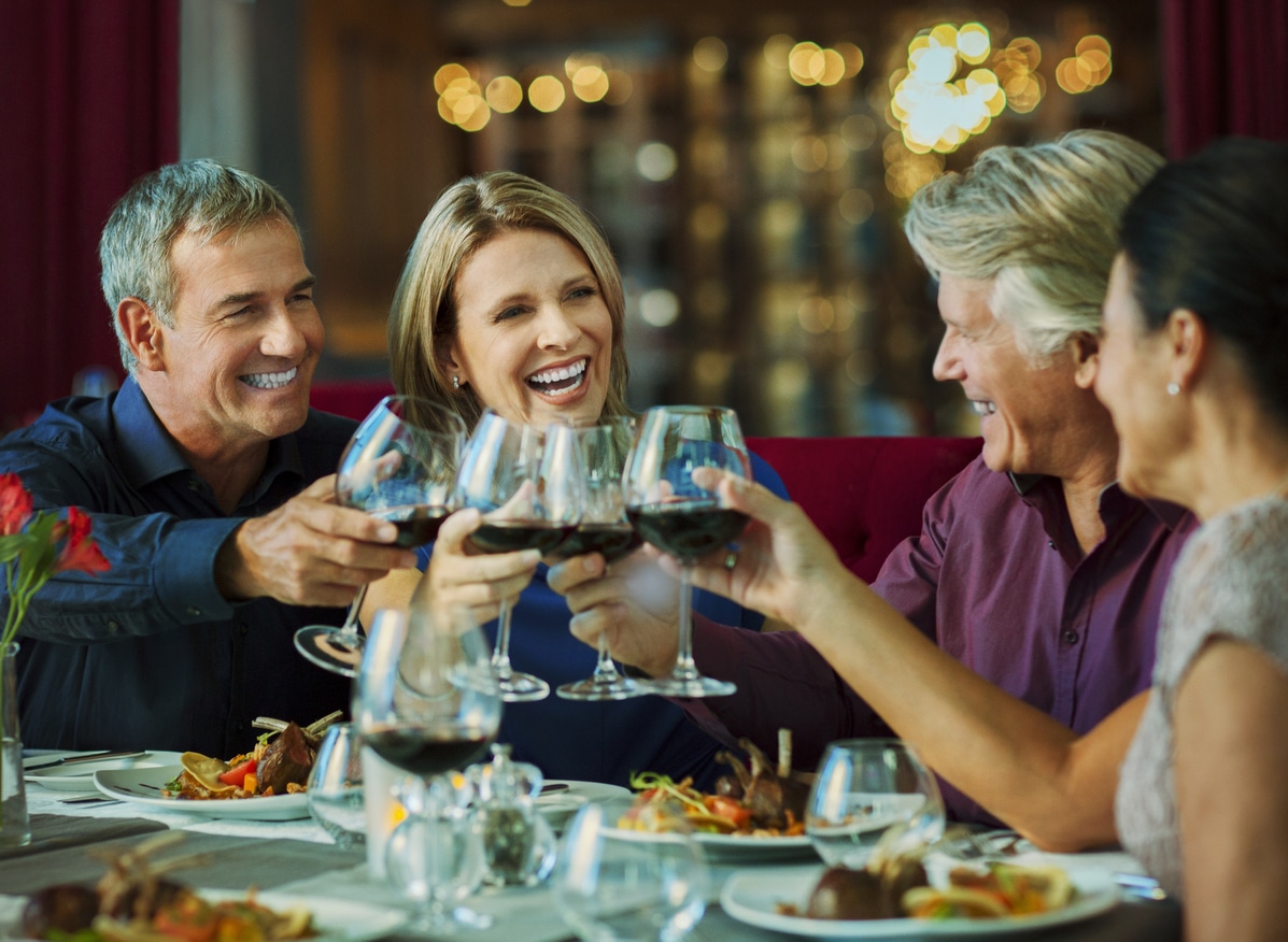 People toasting with red wine in restaurant