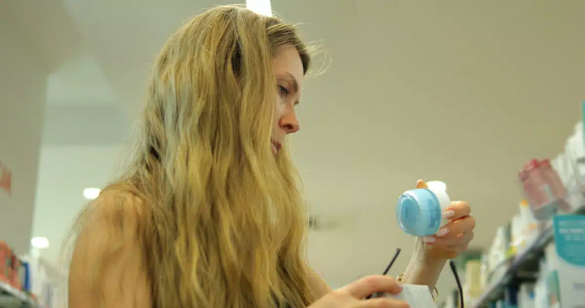 Woman reading makeup ingredients