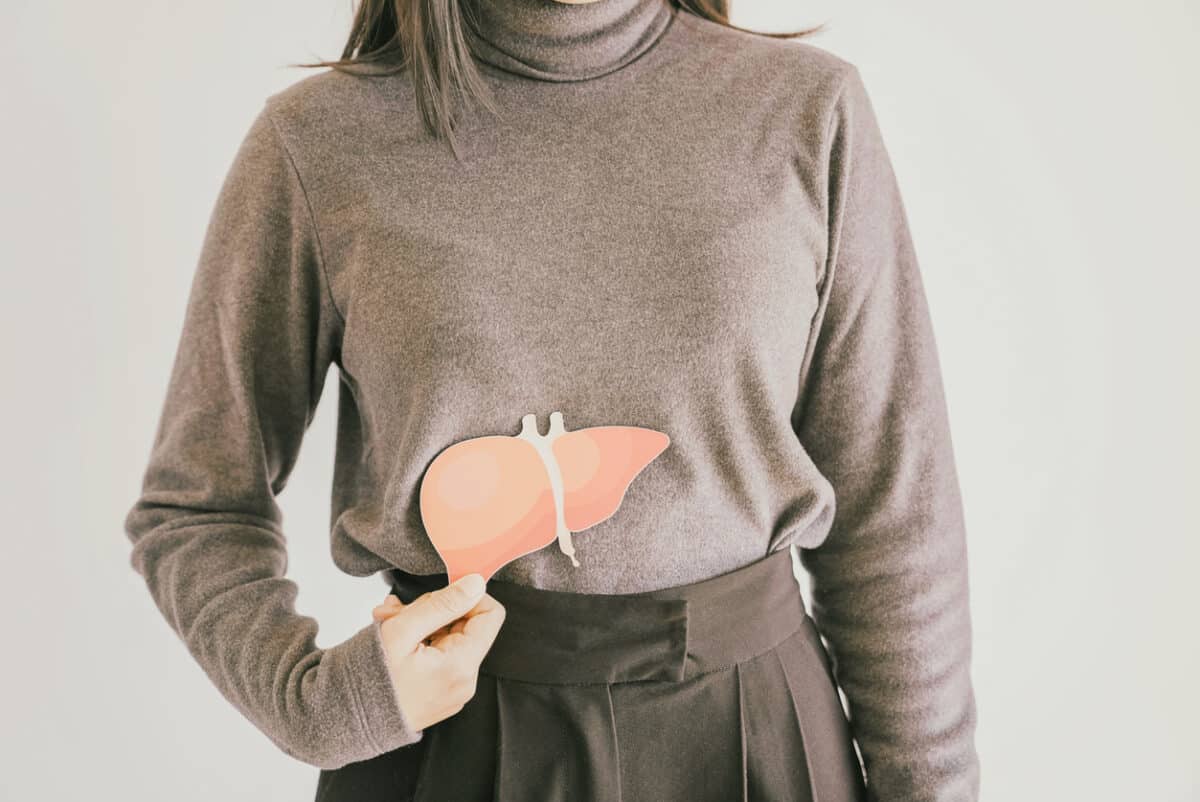 Woman holding a picture of a liver