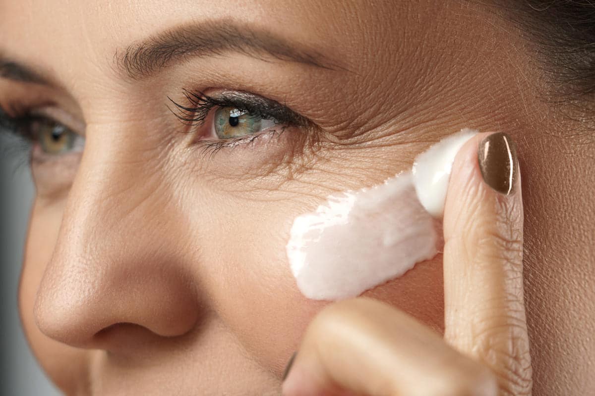 woman applying eye cream