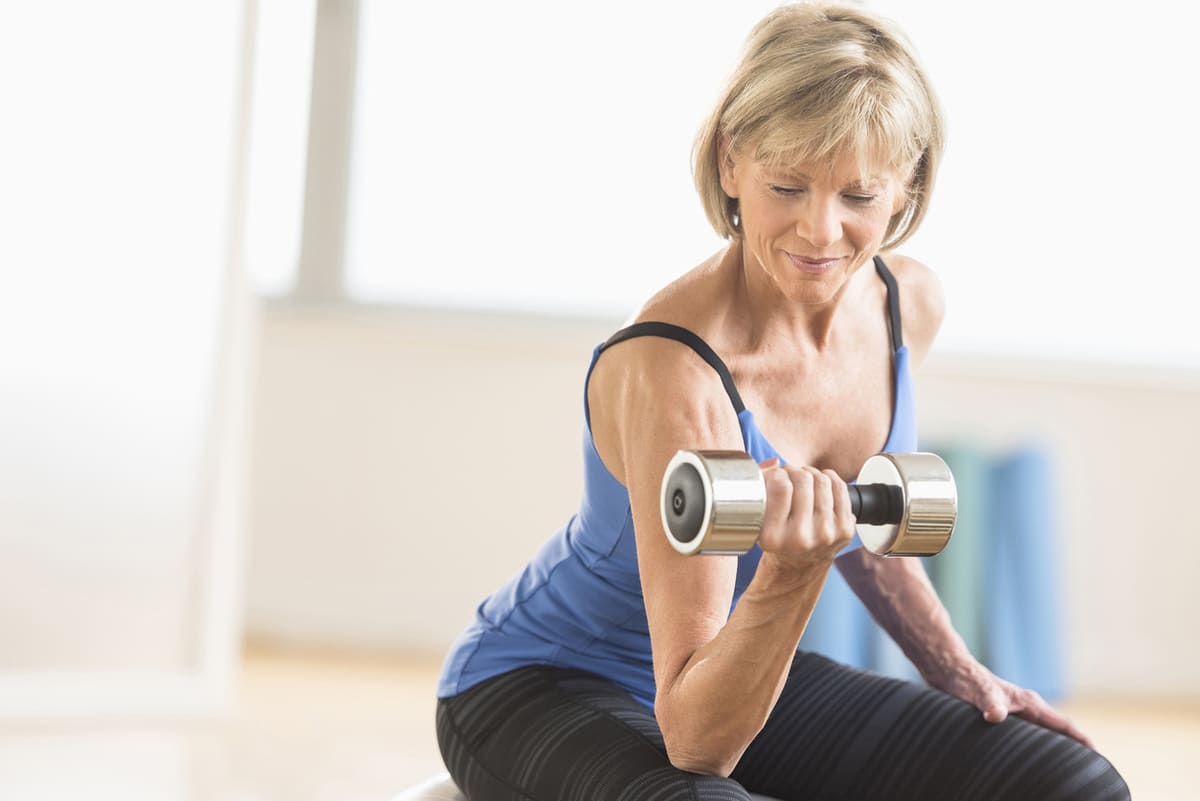 Woman lifting weights, bicep curls