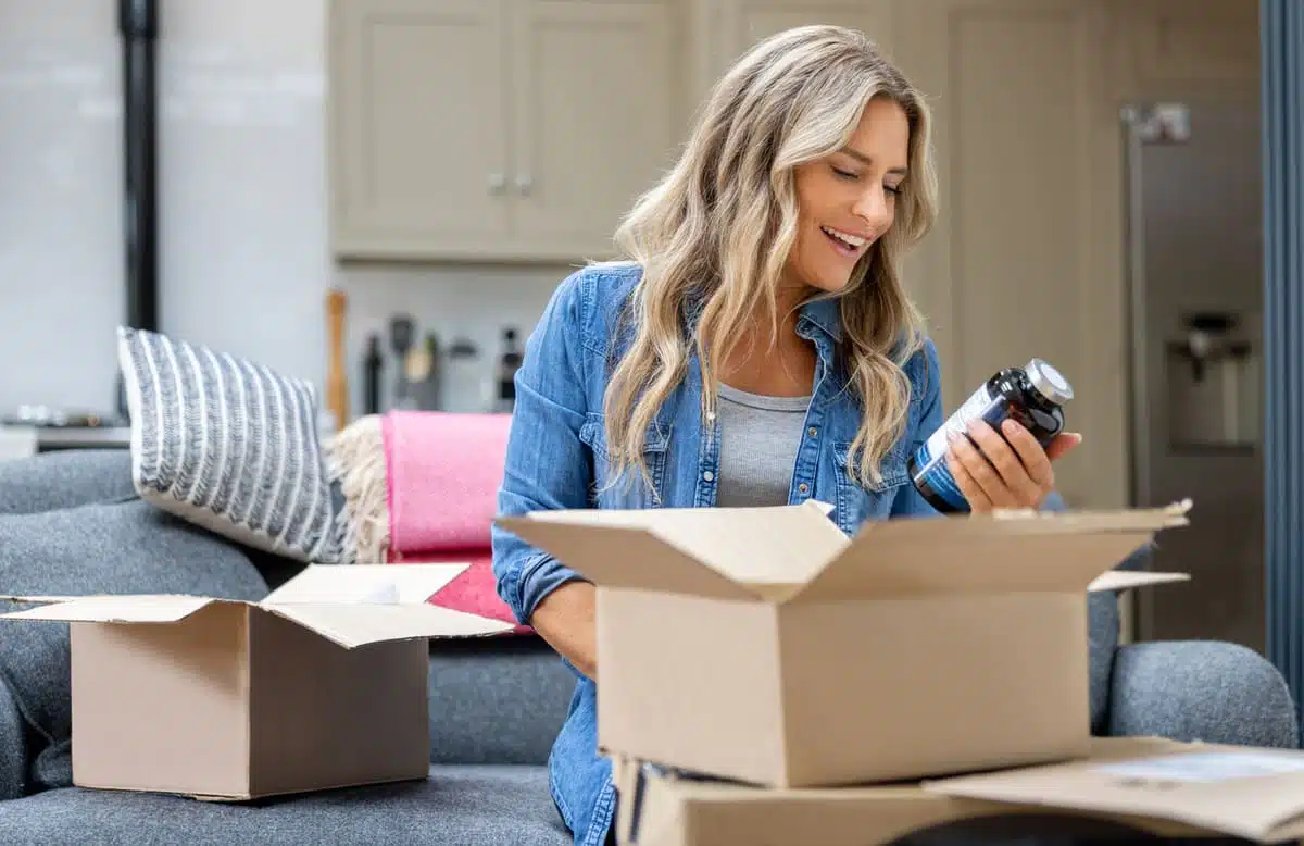 Woman with a box of supplements
