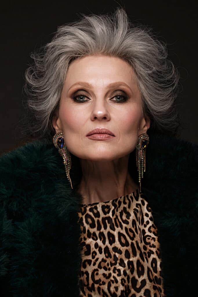 Beautiful grey hair woman, leopard print shirt, smoky eye makeup