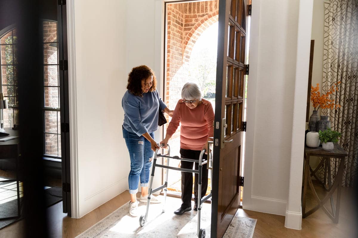 woman with a walker entering home