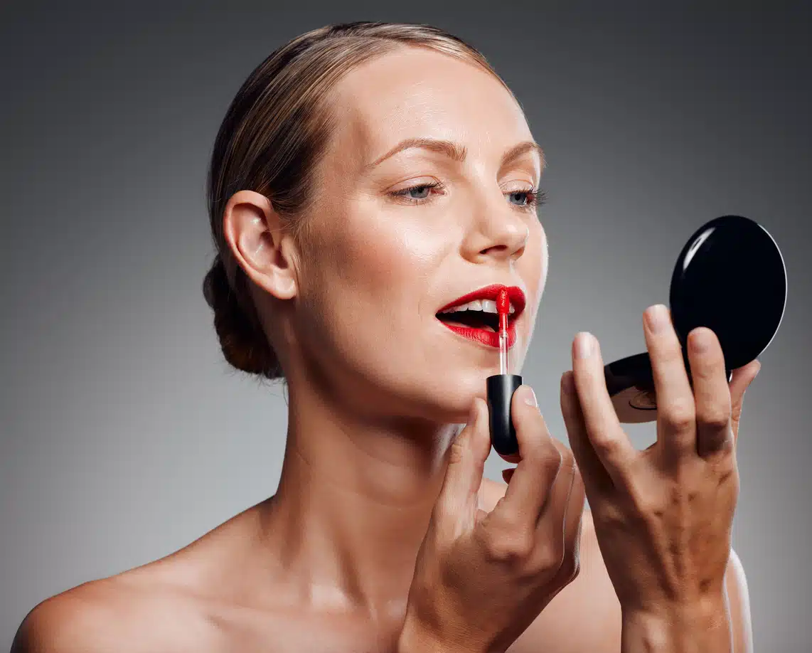 Holiday lip gloss, woman applying makeup