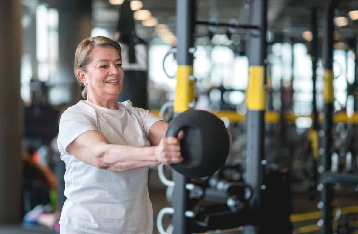 Woman using kettlebells at the gym