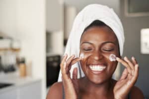 Moisturizer, woman putting cream on face, Albolene