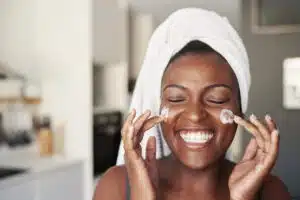 Moisturizer, woman putting cream on face, Albolene