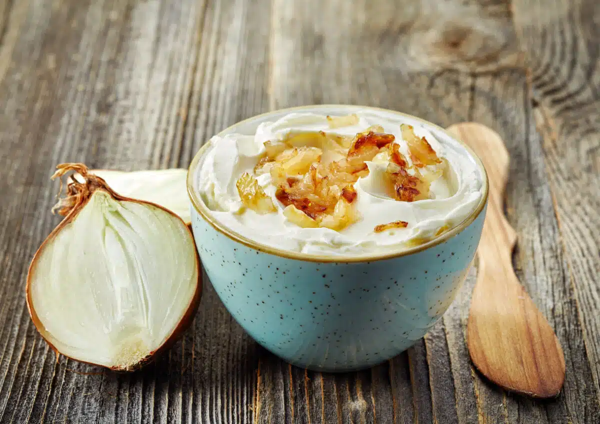 bowl of dip sauce with caramelized onions on wooden table