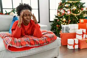Stress during the holidays, unhappy woman, headache