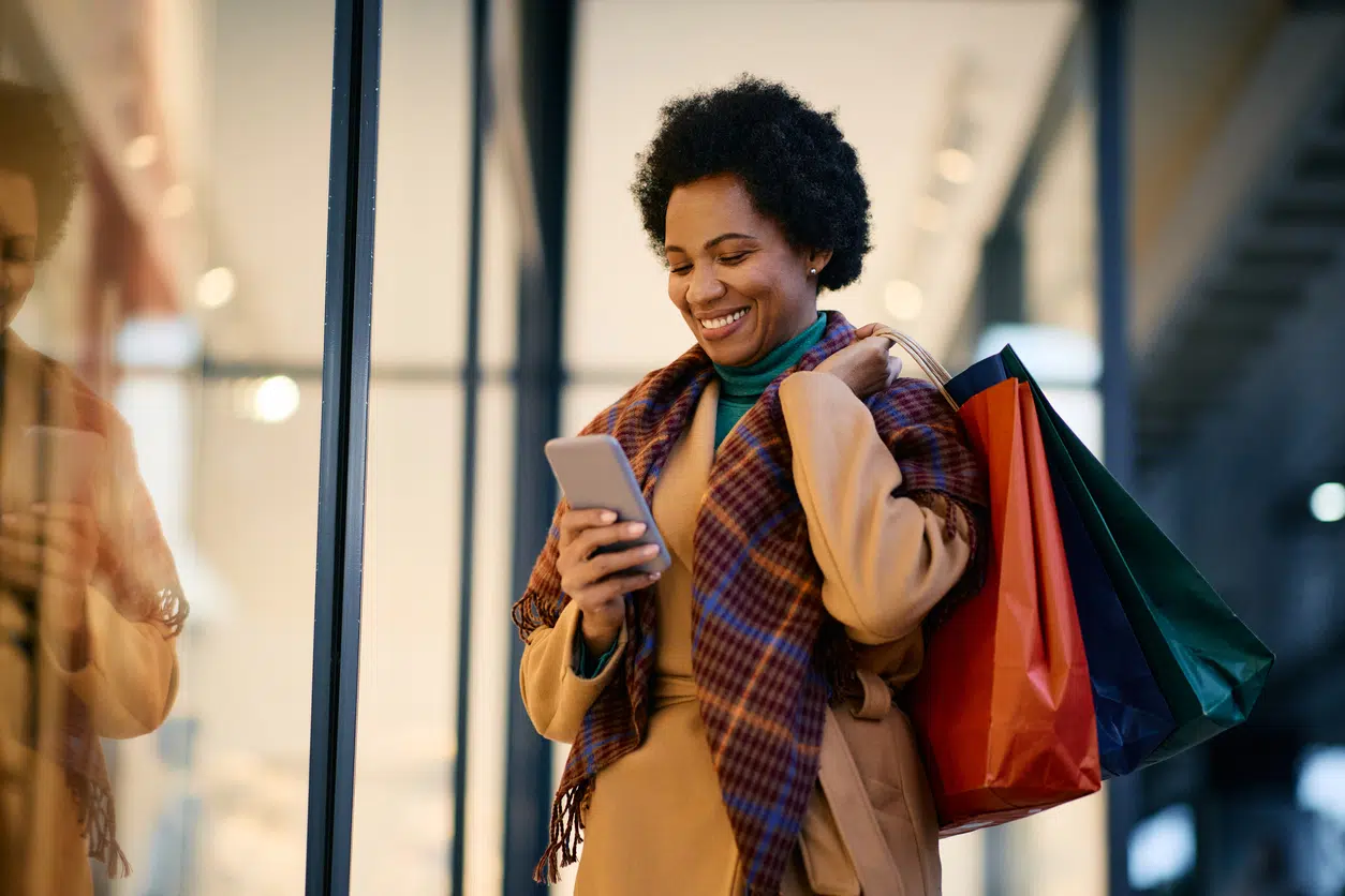 Woman shopping while looking at her phone