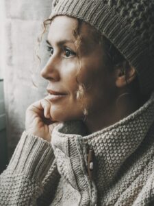 woman looking out the window at winter weather