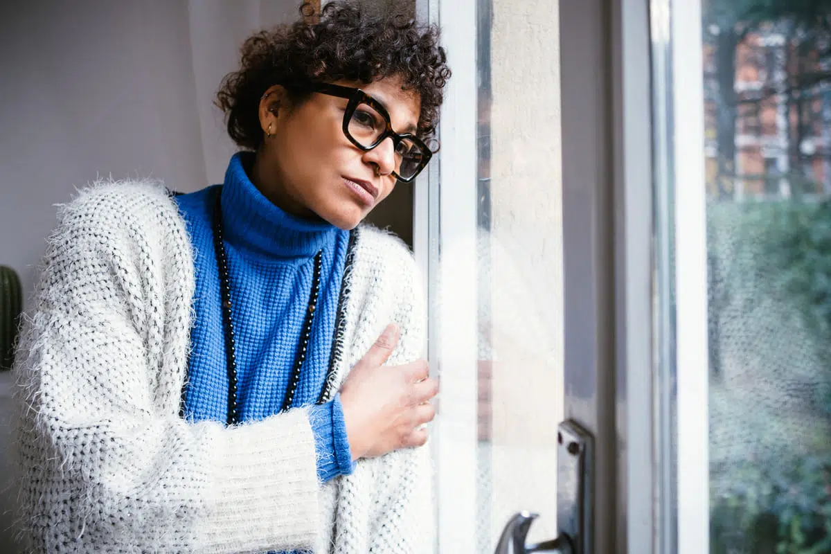 depressed woman looking out the window