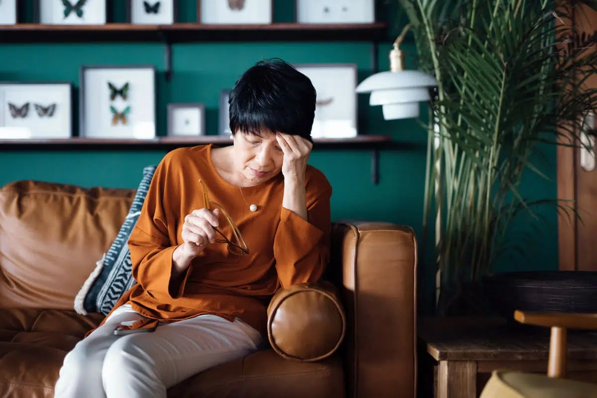 tired woman sitting on the couch