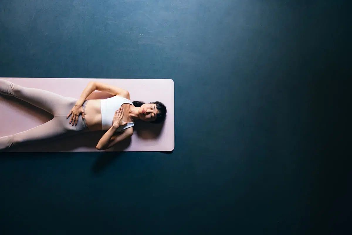 woman doing yoga on a grounding mat