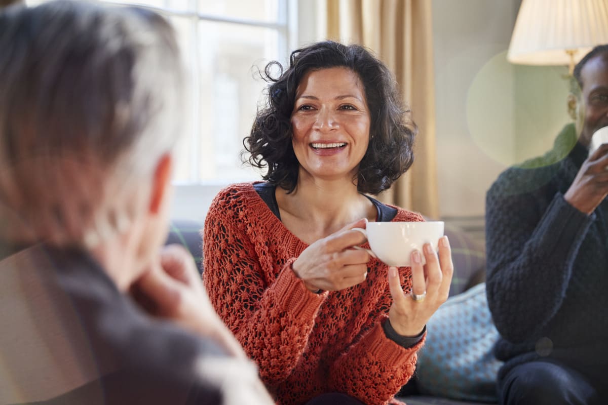 woman having coffee with friends and socializing
