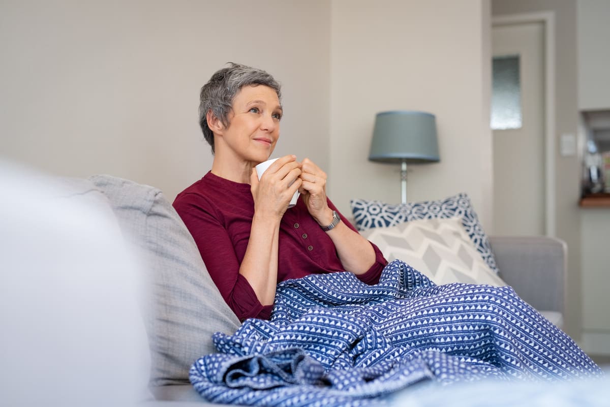 woman sitting on the couch drinking tea