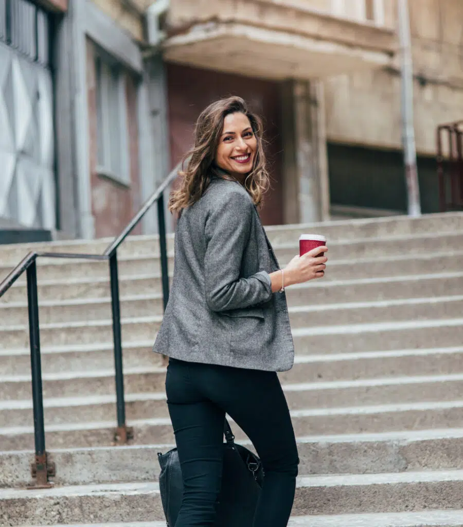 Happy confident woman going up some stairs