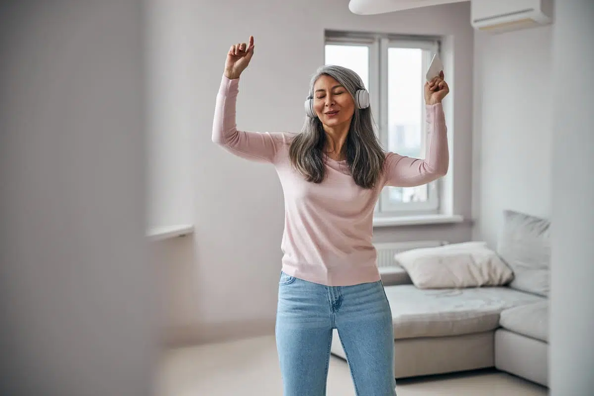 woman dancing with headphones on
