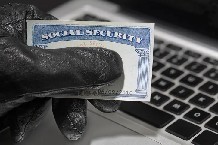 Thief and Social Security Card. Common Scams: Social Security Scams