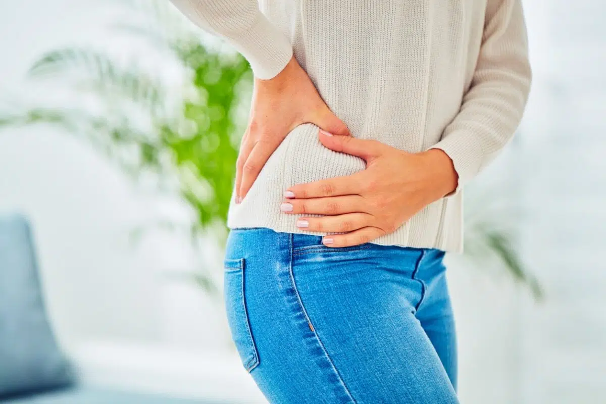Woman holding her hip because of hip pain