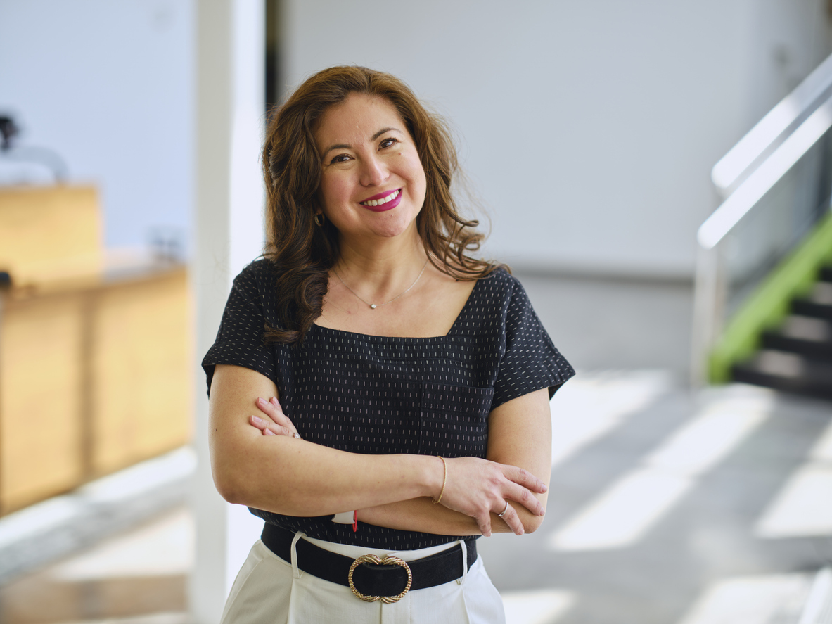 Hispanic woman with medium-length curly hair