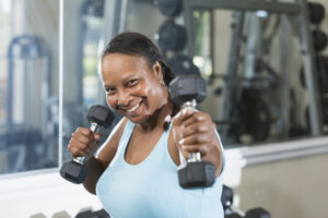 Woman working out in the gym, metabolism-boosting exercises