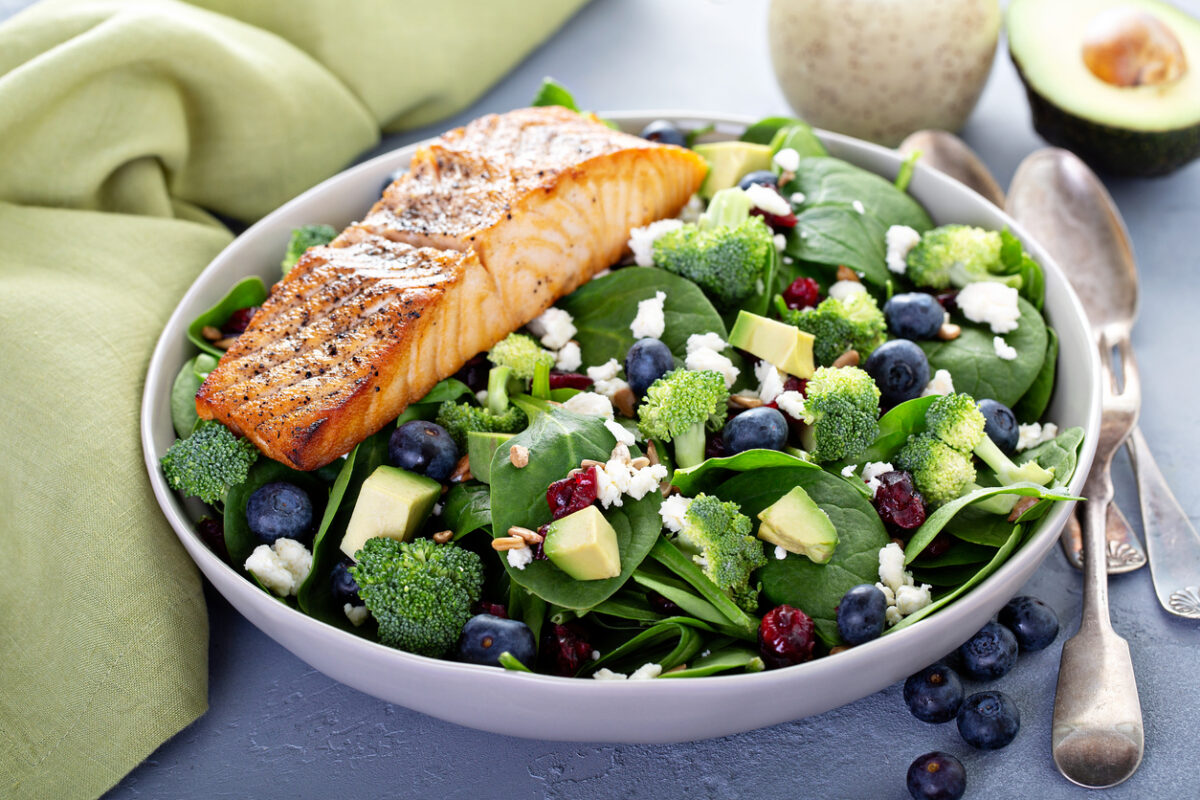 Spinach salad with salmon and berries, healthy diet