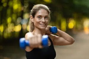 Strong woman, dumbbells, arm workout