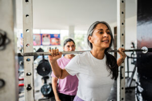 Woman working out at the gym; weight lifting