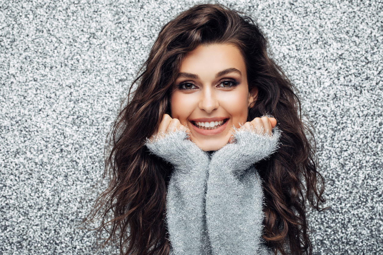 brunette woman, wavy hair, winter hair care tips