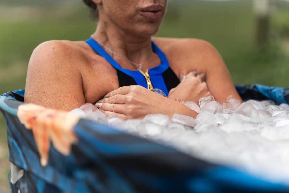 Contrast Therapy for Workout Recovery -- Female athlete taking ice bath for recovery after hard training session