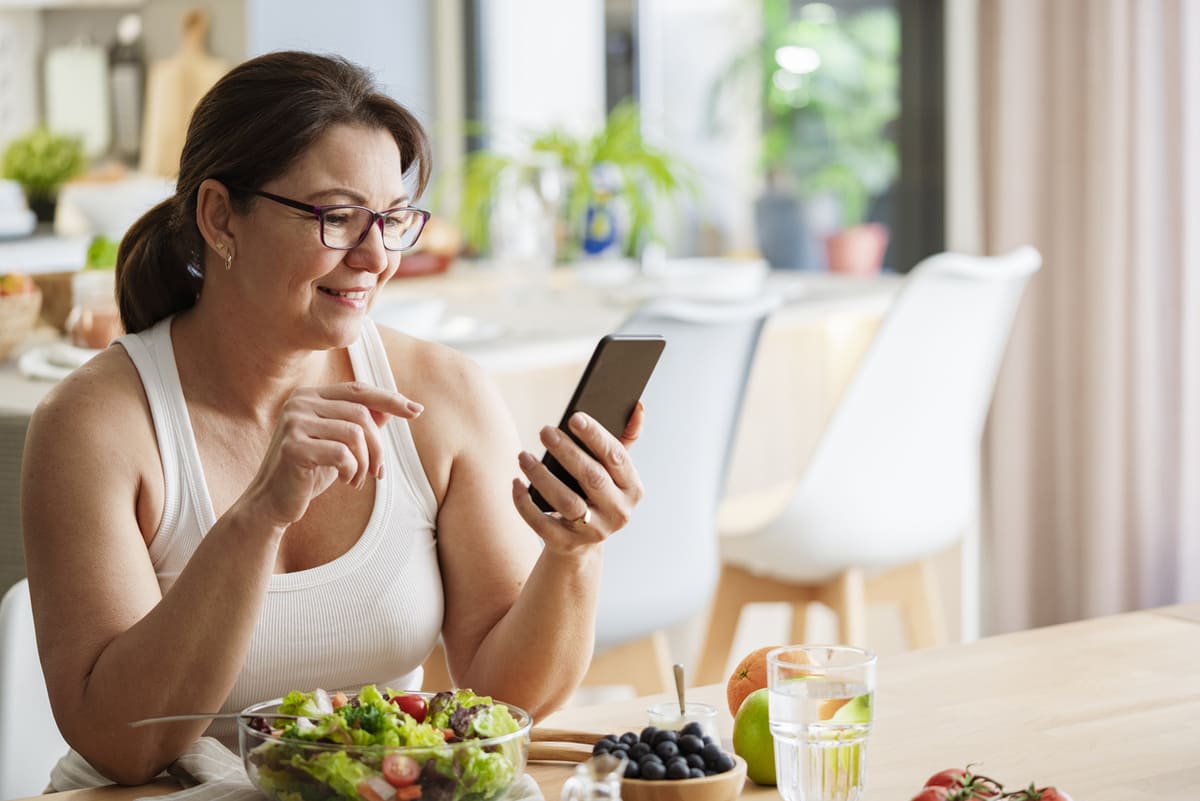 woman smiling while eating healthy