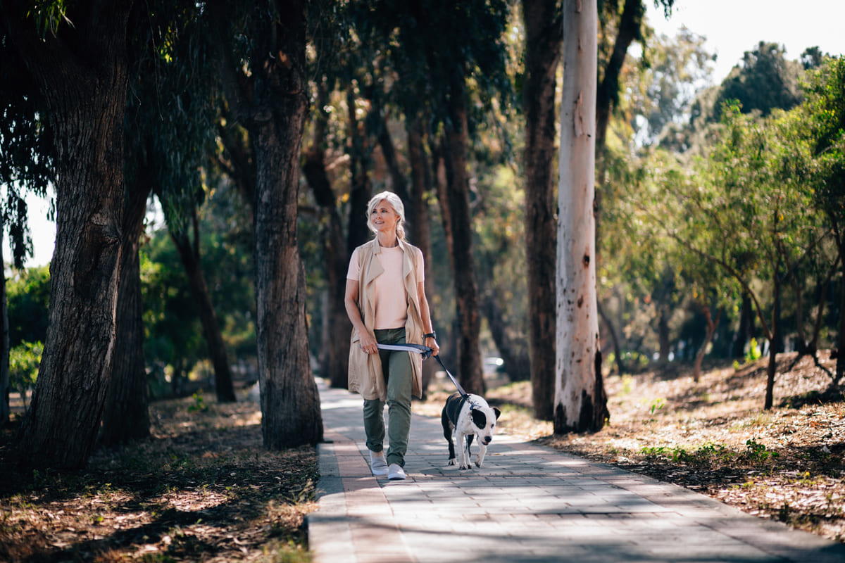 woman walking her dog in the park