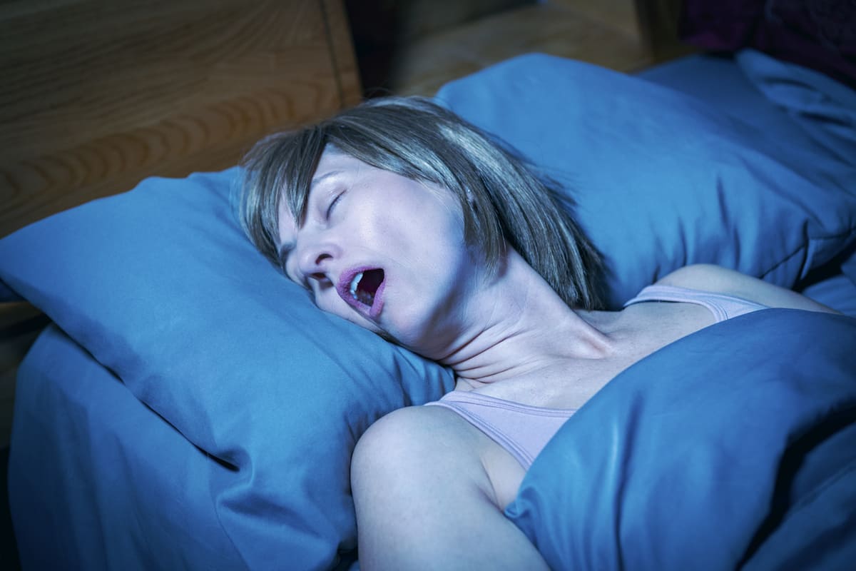 sleep apnea woman snoring in bed