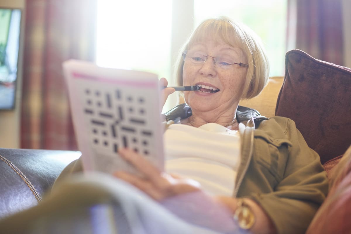 woman doing a crossword puzzle
