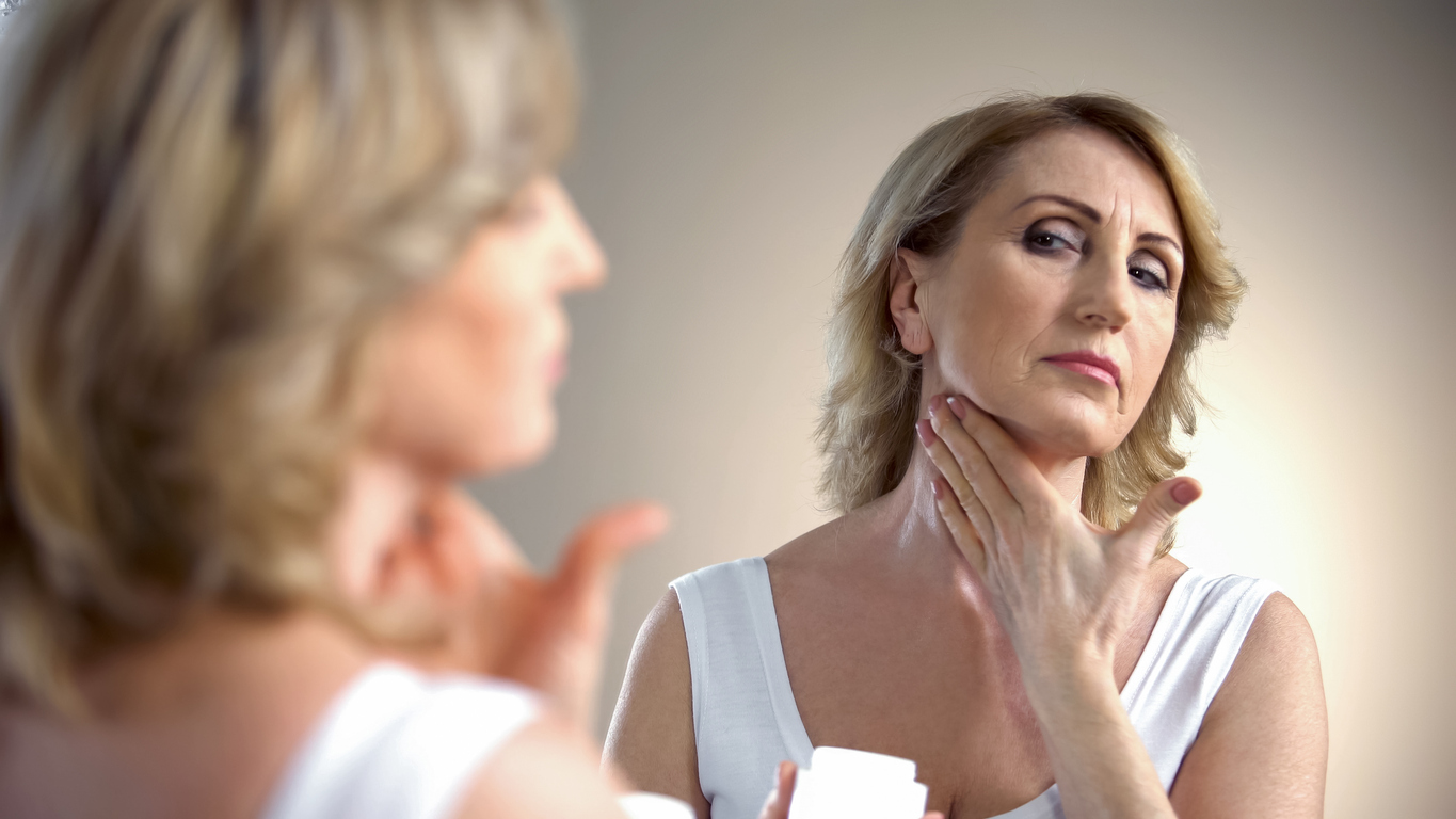 woman applying neck cream