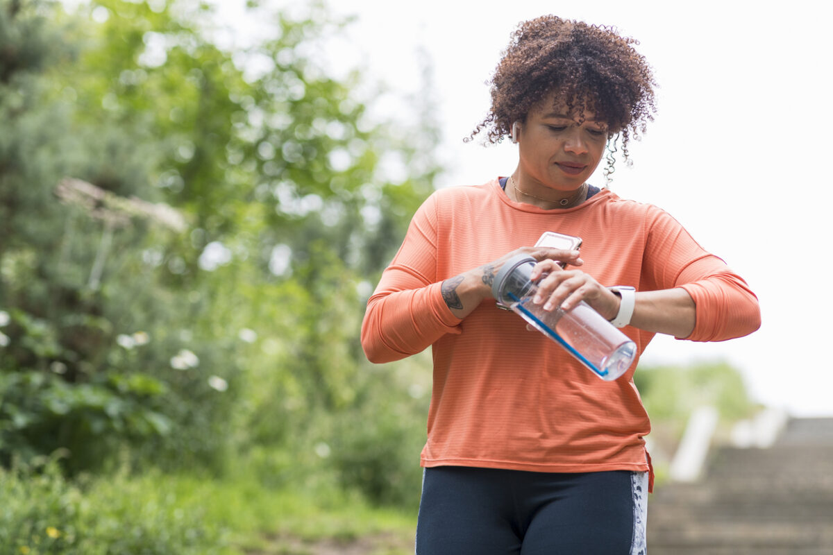 Woman checking watch after a workout; exercise; fitness