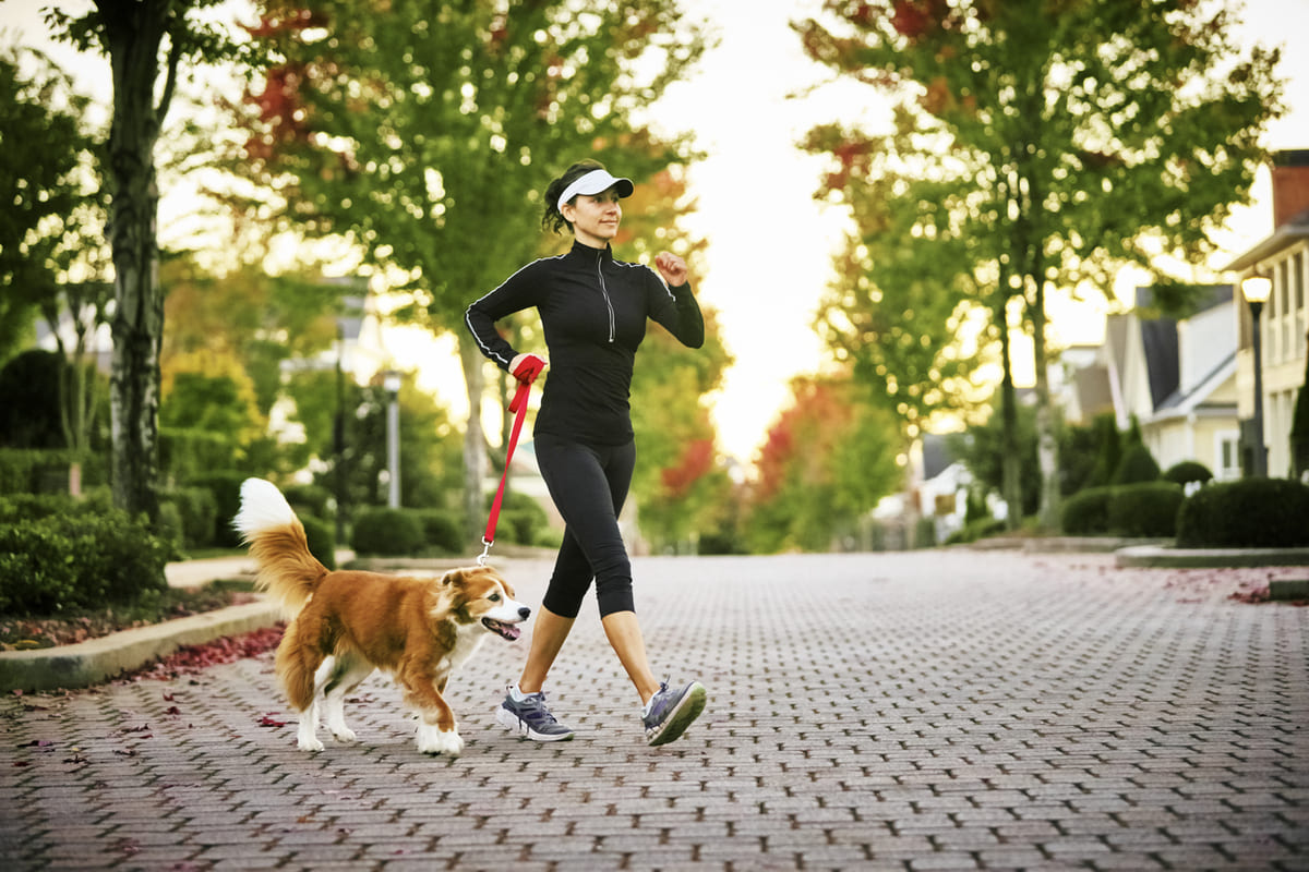woman power walking with her dog