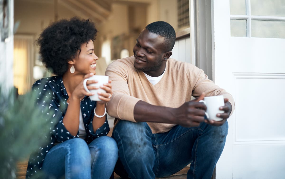 Couple having a conversation on their porch