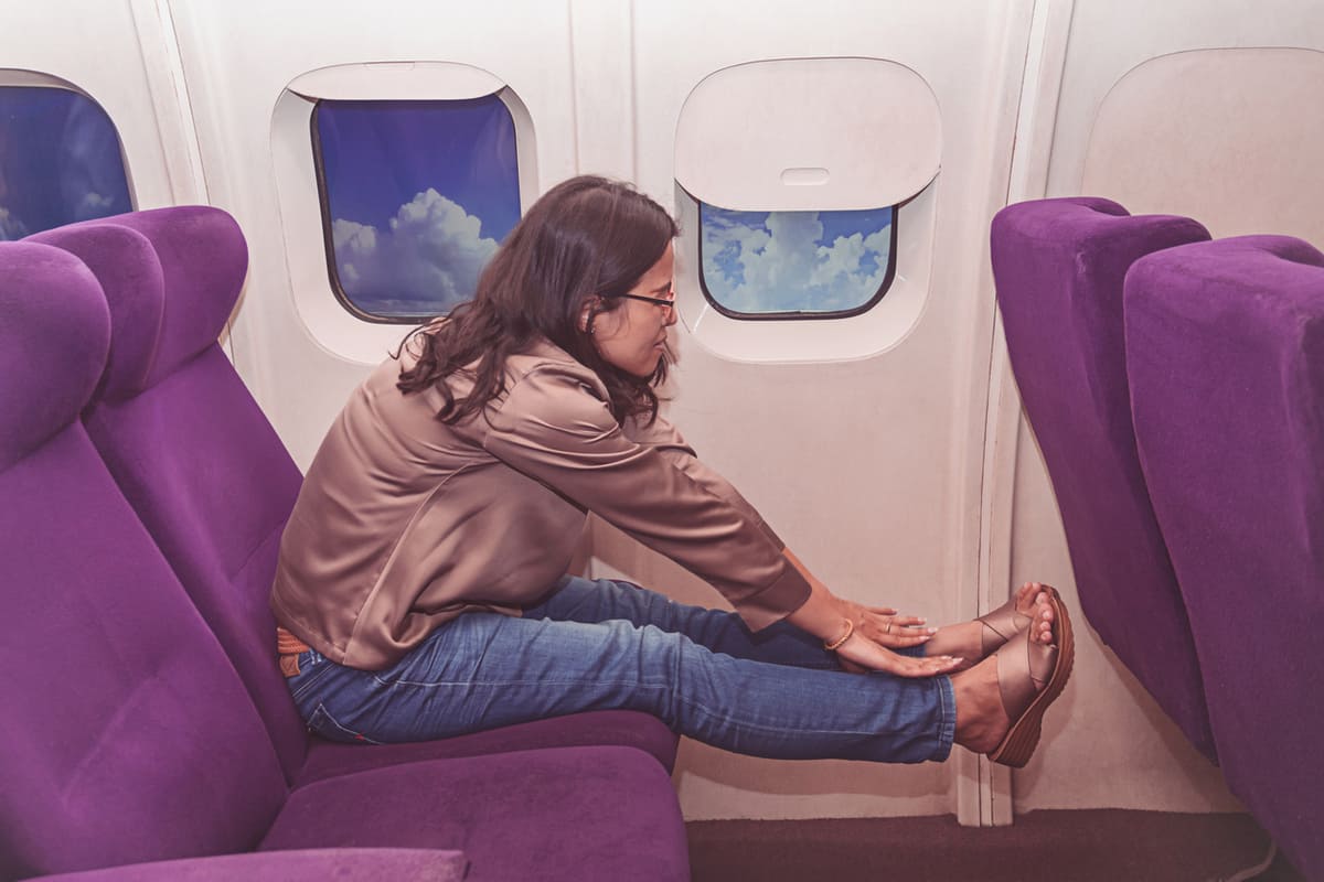 woman stretching on plane