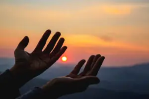 Woman worship on sunset. Why So Many Americans Still Believe in God