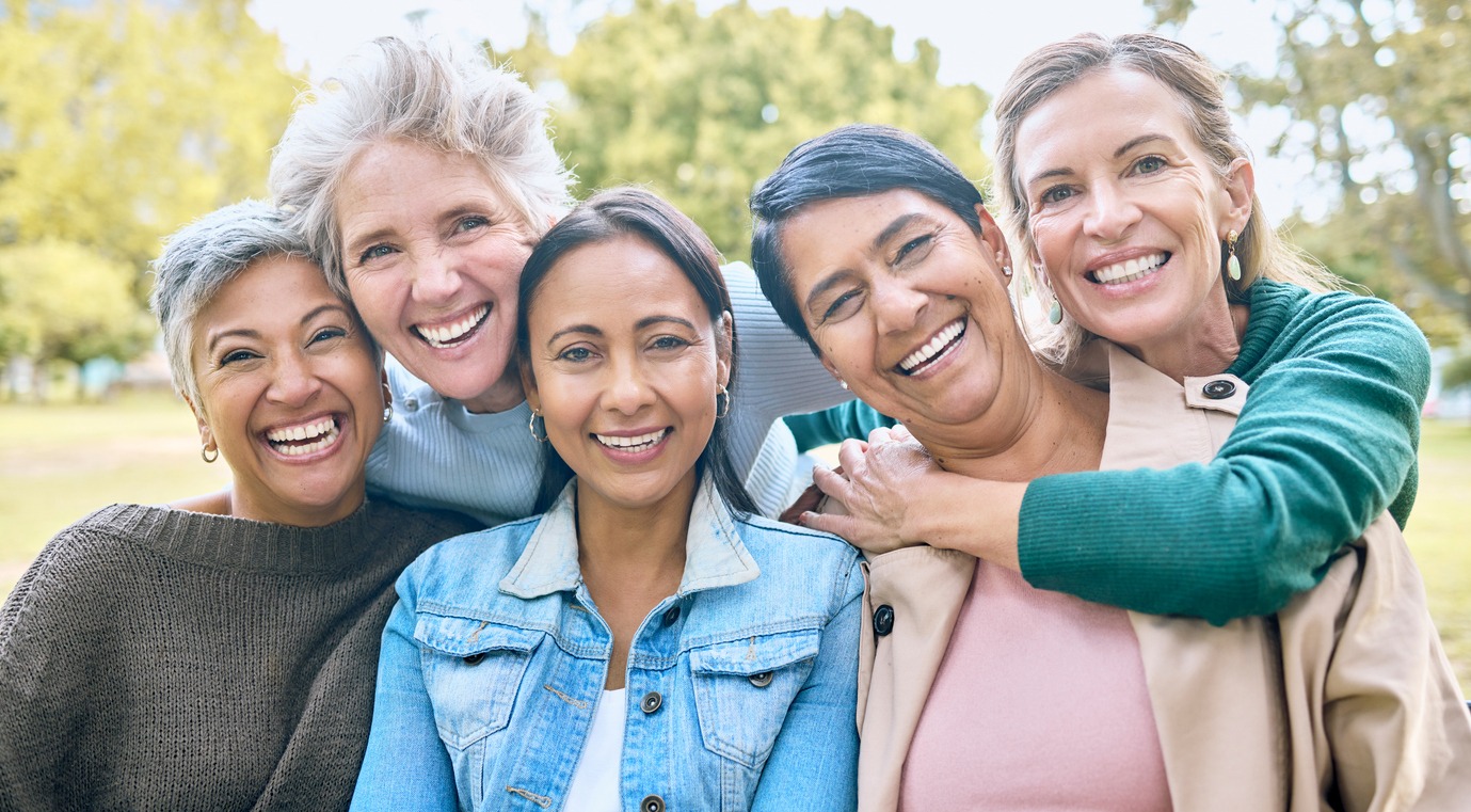 Nature, friends and portrait of group of women enjoying bonding, quality time and relax in retirement together. Diversity, friendship and faces of happy females with smile, hugging and wellness. Age Without Limits movement
